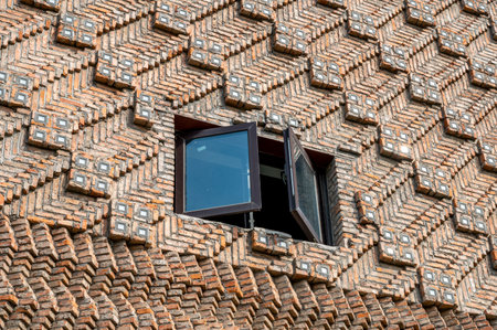 Window on the wall of a building with a lattice pattern.の写真素材