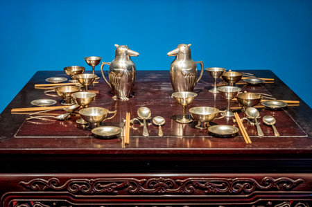 antique brass tableware on a blue background, close-upの写真素材