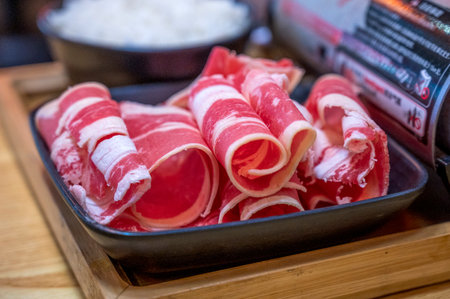 Pork ham slices in black bowl on wooden table, japanese foodの写真素材