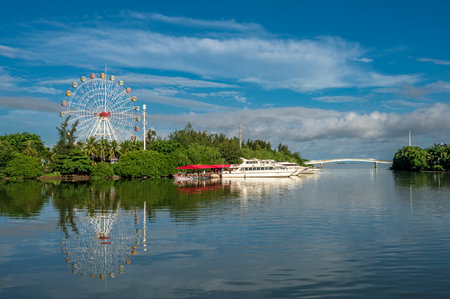 ferris wheel on the lake with blue sky and cloud background.のeditorial素材