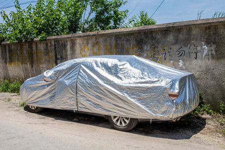 Car covered with plastic wrap on the street in Shenzhen, Chinaの写真素材
