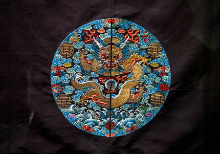 Thai folk art of dragon on black cloth background, Thailand.