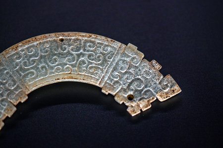 Ancient Roman bronze plate, close-up, isolated on black background