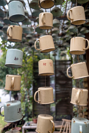 coffee cups hanging on the tree in coffee shop, stock photo