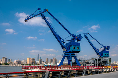 Port crane on the background of the city and the blue sky.の写真素材