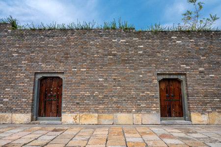Old brick wall with two wooden doors in the ancient city of Xian, China