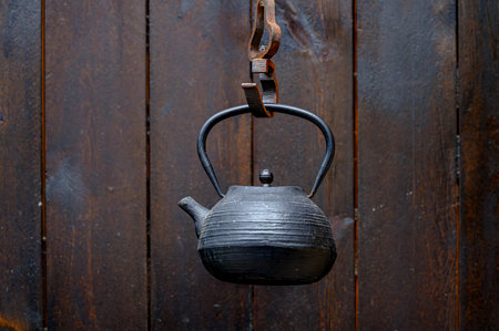 Vintage teapot hanging on a wooden wall, stock photoの写真素材