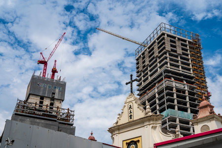 construction site with crane and building under construction against blue sky.の写真素材