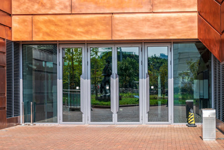 Entrance to a modern office building with glass doors, close-up