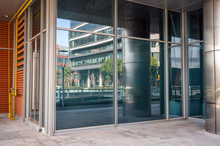 Modern office building with glass facade and reflection in windows. Nobody insideのeditorial素材