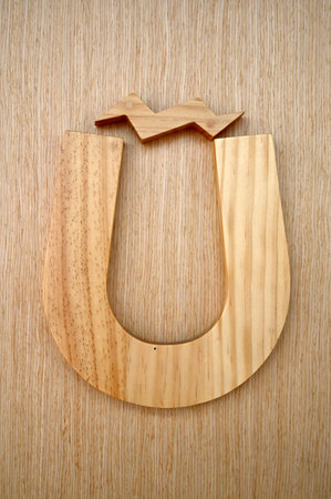 Wooden letter U on a wooden background. 3d render.の写真素材