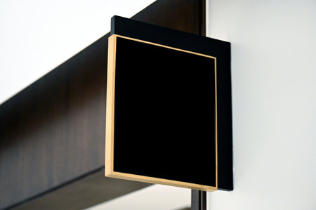 Blank black signboard hanging on the wall. Mock up.の写真素材