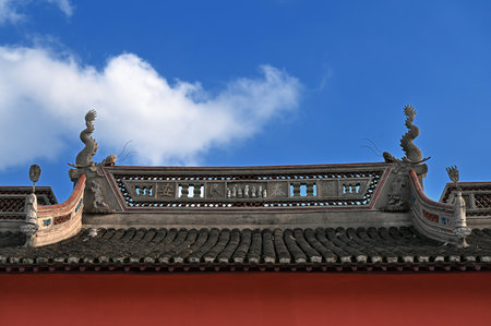 Ancient Chinese temple roof and blue sky background, closeup of photo