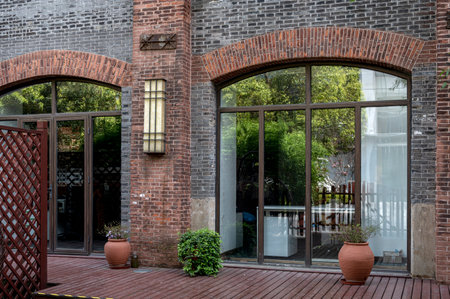 Entrance of a modern house with brick walls and arched windows