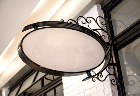 Empty round signboard on the wall in a cafe or restaurant.の写真素材