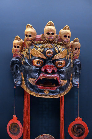 Traditional japanese wooden mask on a black background, closeup of photoの写真素材