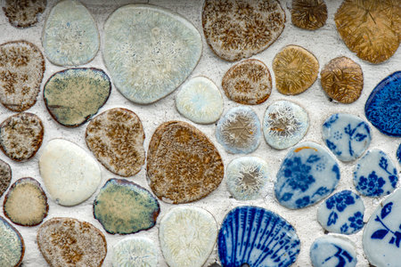 Close up of a decorative stone wall with blue and white pebblesの写真素材
