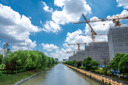 Construction site with crane on blue sky and white cloud background