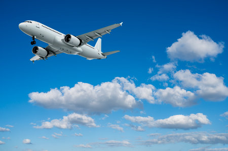 Airplane flying in the blue sky with white clouds. Travel concept