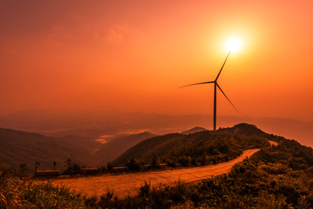 Wind turbine on the mountain with beautiful sky at sunset, Thailand.の写真素材