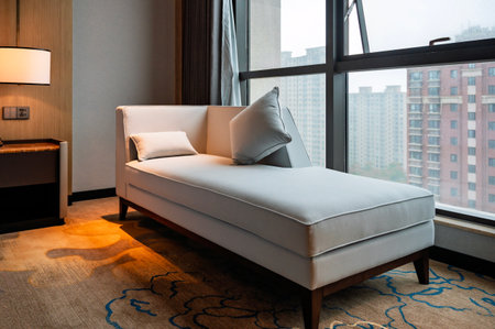 Interior of a hotel room with a large window and a sofaの写真素材