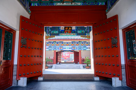 Chinese temple gate with red door and chinese pattern, closeup of photoの写真素材