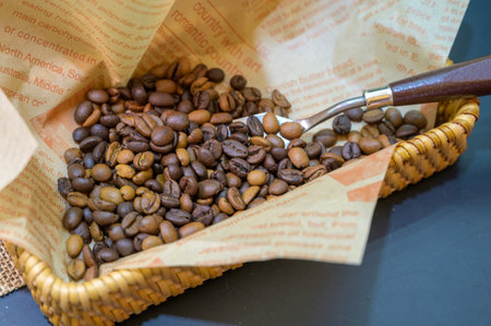 Coffee beans in a wicker basket with a coffee grinderの写真素材