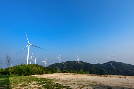 Wind turbines in the field with blue sky background, alternative energy source