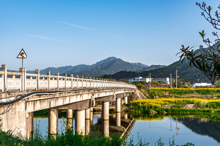 Bridge over the river and the mountains with blue sky in the backgroundの写真素材