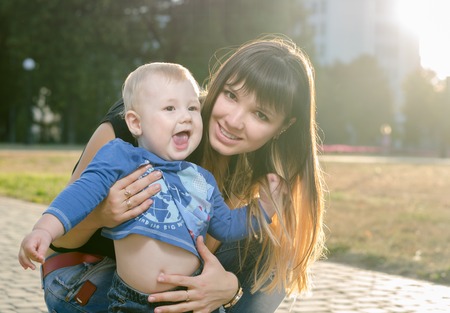 young beautiful mother with her little son in the park