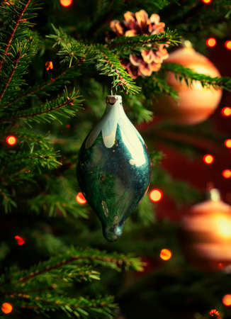Vintage Christmas toy on the Christmas fir tree, toned image, selective focusの写真素材