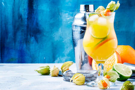 Alcoholic cocktail summer breeze with syrup, lime, orange, beer and ice, selective focusの写真素材