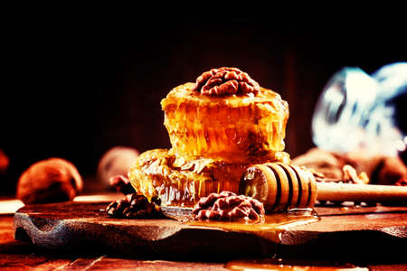 Autumn honey and walnuts, useful and delicious food, black background, selective focus, shallow DOFの写真素材