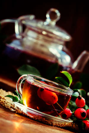 Curative tea with rosehip, folk medicine, Vintage wood background, selective focusの写真素材