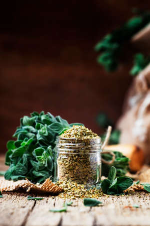 Dried and fresh oregano, vintage wood background, rustic style, selective focusの写真素材