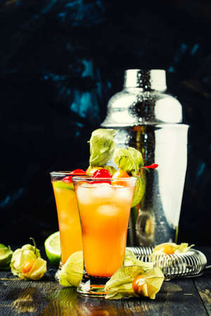 Alcohol cocktail with juice, ice, bitter and vodka, dark background, selective focusの写真素材
