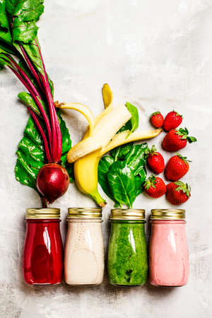 Multicolored juices and smoothies of fresh vegetables, fruits and berries, top view, food backgroundの写真素材