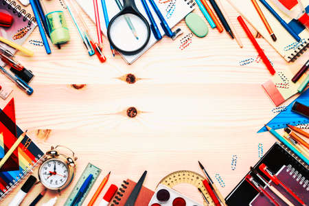 Back to school background with space for text, notebooks, pens, pencils, other stationery on light wooden school desk, education concept, flat lay, top viewの写真素材