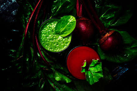 Healthy smoothies made of spinach and beets, fresh vegetables, food background, flat layの写真素材