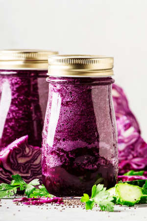 Healthy vegan detox purple smoothies or juice from red cabbage, cucumbers with chia seeds in glass...