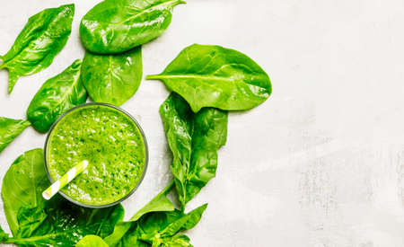 Cocktail of spinach and green vegetables and fruit, drink background, top viewの写真素材