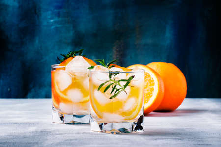 Refreshing drink with orange, rosemary and ice, selective focusの写真素材