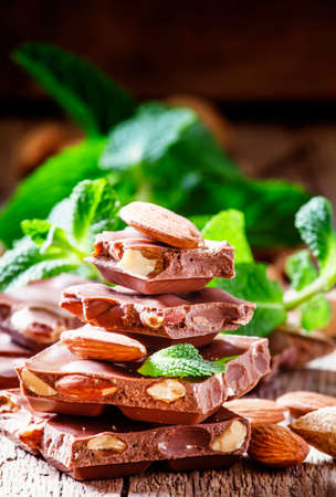 Chocolates with sweet almonds and mint, vintage wooden background, selective focusの写真素材