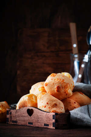 Homemade sweet custard buns, wooden bowl, rustic kitchen table background, place for text, selective focusの写真素材