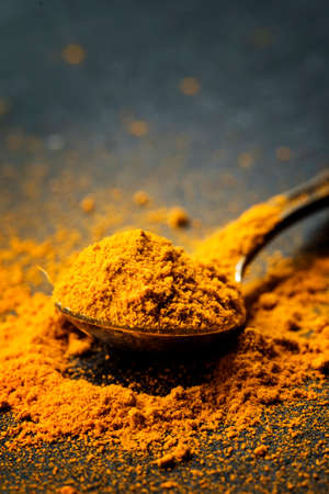 Ground turmeric or curcuma, black background, close-up shot, selective focusの写真素材