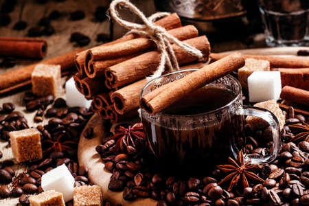 Espresso, coffee maker, spilled coffee beans, spices, sugar, vintage wooden background, selective...