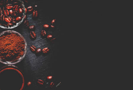 Food background: coffee beans, ground coffee, fresh espresso, dark background, top view and toned imageの写真素材