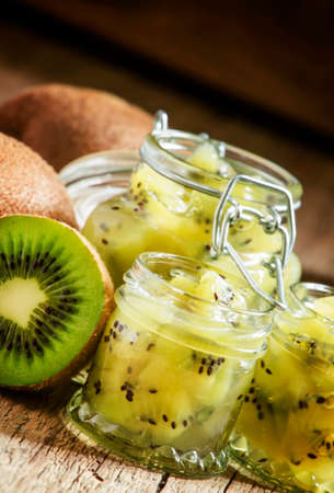 Kiwi jam in the glass jars, vintage wooden background, selective focusの写真素材