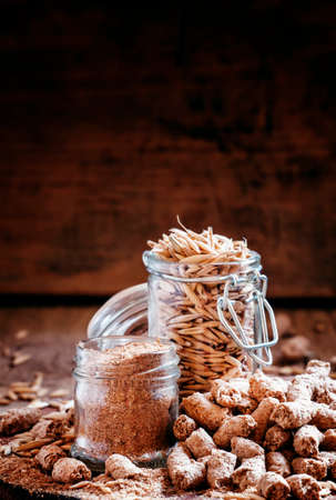 Oat bran, grain oats, oat flour, in glass jars, vintage wooden background, selective focus