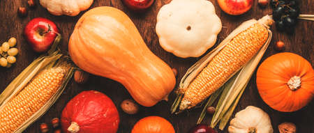Thanksgiving background, food autumn harvest concept. Rustic table with Apples, pumpkins, nuts,...